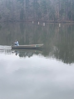 Person riding in boat on Lake Fisher